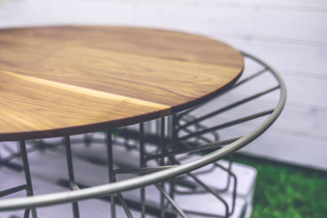 services-02 Stylish round wooden table with metal frame, perfect for modern outdoor spaces.
